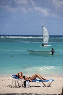 Dominican Republic, Punta Cana, Higuey, Bavaro, Bavaro Beach, young woman sunbathing
