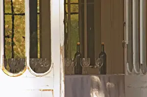 Wine Tasting Prints: Door open to the garden with inside a table set with glasses and bottles for tasting wine