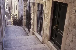 Historic Town Prints: Doors to many homes line the narrow street in a residential area of Old Town Dubrovnik