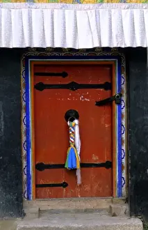 Forbidden Prints: Doorway with welcome scarfs on knob of home in capital city of Lhasa Tibet China