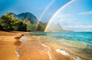 Shoreline Prints: A double rainbow over the coastline of a Hawaiian island with mountains