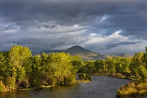 Dramatic stormy sunrise light strikes the Big Hole River near Melrose, Montana, USA