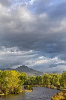 Dramatic stormy sunrise light strikes the Big Hole River near Melrose, Montana, USA