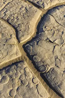 Lakebed Prints: Dried mud cracks of ancient lakebed in The Mesquite sand dunes in Death Valley National Park
