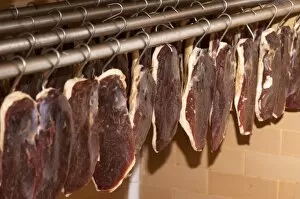 Ducks breast (magret or filet de canard) hanging on hooks in a temperature controlled