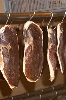 Ducks breast (magret or filet de canard) hanging on hooks in a temperature controlled
