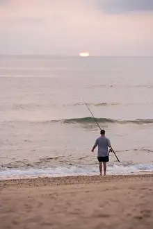 Angling Prints: Early morning surfcasting on the beach at Cape Cod National Seashore in Massachusetts