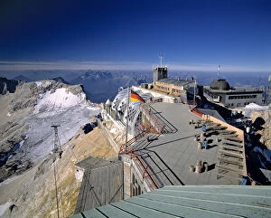 Early visitors to the summit enjoy the view from the Zugspitze in the Bavarian Alps