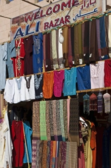 Images Dated 6th February 2009: Egypt, Aswan. Clothing shops in the market