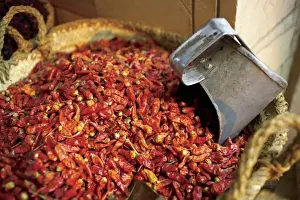 Cairo Prints: Egypt, Cairo, Souk Market, Hot red peppers with a scoop in them at a vendor selling Spices