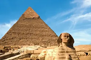 Sphinx Prints: Egypt, Cairo, The Sphinx sits before and the Great Pyramid of Khufu (Cheops)