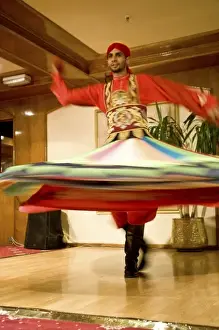 Cairo Prints: Egypt, Cairo. Whirling dervish dazzling GCT audience on Nubian Night aboard MS River