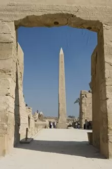 Images Dated 30th January 2006: Egypt, Luxor. The obelisk at Karnak Temple rises tall above visitors to the ancient ruins