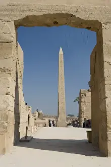 Hieroglyphic Prints: Egypt, Luxor. The obelisk at Karnak Temple rises tall above visitors to the ancient ruins