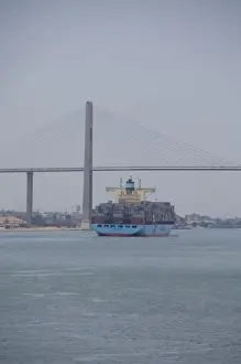 Images Dated 9th May 2009: Egypt, Suez Canal. Cargo ship passing under Bridge of Peace (aka Peace Bridge)