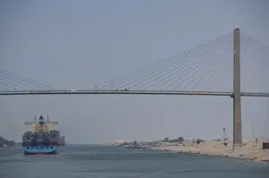 Images Dated 9th May 2009: Egypt, Suez Canal. Cargo ship passing under Bridge of Peace (aka Peace Bridge)