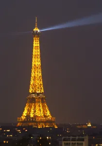 Eiffel Tower Prints: The Eiffel Twoer in Paris illuminated at night against a dark blue black sky, search
