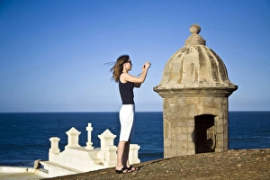 Lookout Prints: El Morro fortress and Church. Old San Juan. Puerto Rico. Woman taking a photo