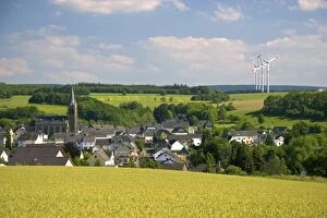 Images Dated 17th June 2006: Electricity wind generators near a village in northwest Germany
