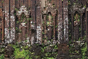 Prints of Encroaching moss and Hindu statues at My Son Sanctuary, Quang Nam Province, Vietnam Images Dated 2017 December: Encroaching moss and Hindu statues at My Son Sanctuary, Quang Nam Province, Vietnam