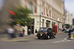 England, London. Black taxicab zooms through Londons streets