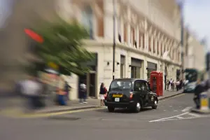 Taxi Prints: England, London. Black taxicab zooms through Londons streets