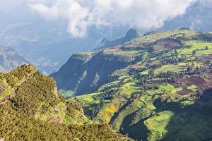 Prints of Ethiopia. Amhara. North Gondar. View of farms and a village in the Ethiopian highlands Images Dated 2024 April: Ethiopia. Amhara. North Gondar. View of farms and a village in the Ethiopian highlands