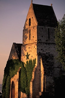 Normandy Prints: EU, France, Normandy, Calvados, Cricqueboeuf. Sunset light on 12th century town church