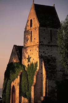 EU, France, Normandy, Calvados, Cricqueboeuf. Sunset light on 12th century town church