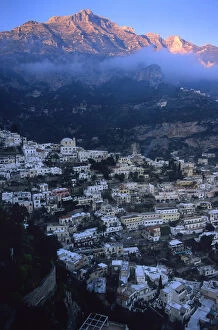 Images Dated 26th May 2006: EU, Italy, Positano. Sun hits the mountain peaks behind Positano, Italy along the