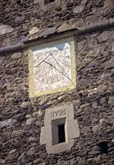 Adornment Prints: Europe, Andorra. An old sun dial adorns a stone tower in Andorra