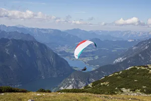 Europe, Austria, Dachstein, Paraglider soaring above Lake Hallstatt