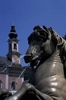 Europe, Austria, Salzburg. Rezidenzplatz fountain and St. Michaelskirche