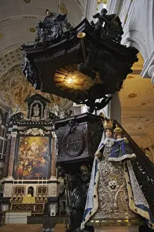 Jesuit Prints: Europe, Belgium, Antwerp. A Madonna and Child statue stands by an ornate oak pulpit