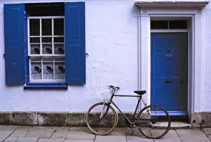 White Washed Prints: Europe, England, Oxfordshire. A bicycle leans against a white-washed home in Oxfordshire in England