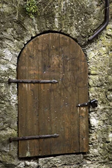 Europe, Estonia, Tallinn. Detail of old wooden door in stone wall