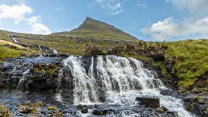 Images Dated 11th August 2020: Europe, Faroe Islands. View of waterfall cascading down a hillside in the Faroe Islands