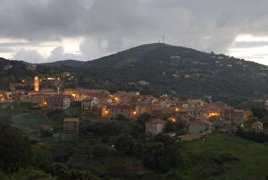 Images Dated 28th April 2006: Europe, France, Corsica, Piana. Lights of Piana at dusk with storm clouds