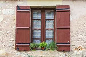 Images Dated 23rd July 2020: Europe, France, Dordogne, Hautefort. A brown shuttered window on a house in the town of