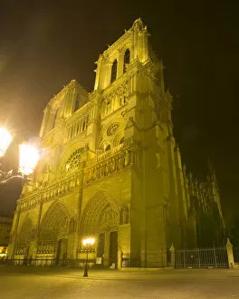 Images Dated 26th June 2006: Europe, France, Paris. Exterior close-up of Notre Dame Cathedral lit at night. Credit as