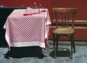 Cafe Tables and Chairs Gallery: Europe, France, Paris. A sidewalk table for one welcomes a diner in the Montmartre