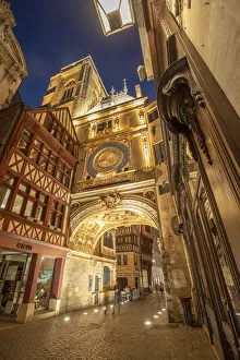 Rouen Prints: Europe, France, Rouen. Medieval clock on building at twilight