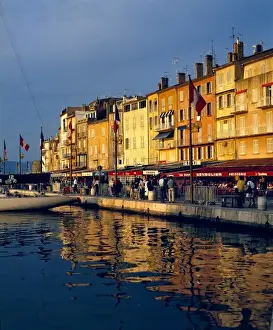 Department Alpes Maritimes Prints: Europe, France, St. Tropez. The cafes along the harbor are filled with people-watchers in St