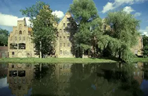 Storage Prints: Europe, Germany, Lubeck. Old salt storage building reflecting on the river
