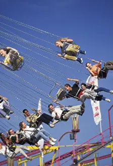 Carnival Prints: Europe, Germany, Munich. Visitors enjoying the ride high above the crowd during Octoberfest