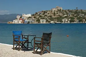 Dodecanese Prints: Europe, Greece, Kastellorizo: chairs on the edge of Kastellorizo harbour