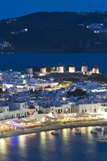Images Dated 1st June 2005: Europe, Greece, Mykonos, Hora. Night view overlooking harbor with illuminated windmills