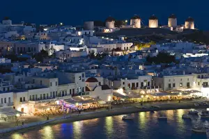Hora Prints: Europe, Greece, Mykonos, Hora. Night view overlooking harbor with illuminated windmills