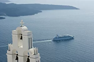 Europe, Greece, Santorini. Blue church dome and white bell tower overlooking a luxury yacht