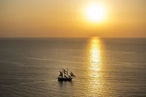 Images Dated 9th June 2014: Europe, Greece, Santorini, Cyclades. Sailboat on ocean at sunset